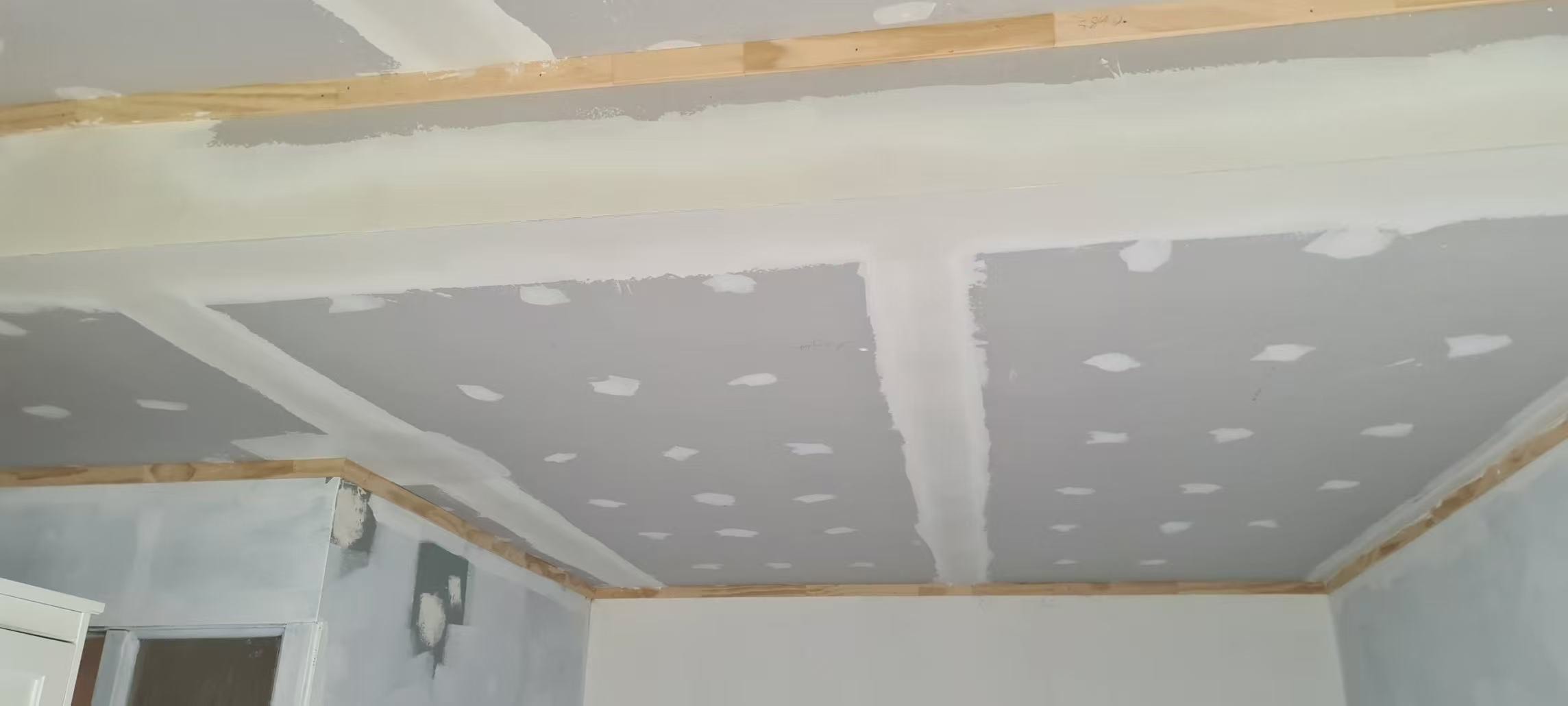 Bedroom ceiling and walls before repainting with visible repairs